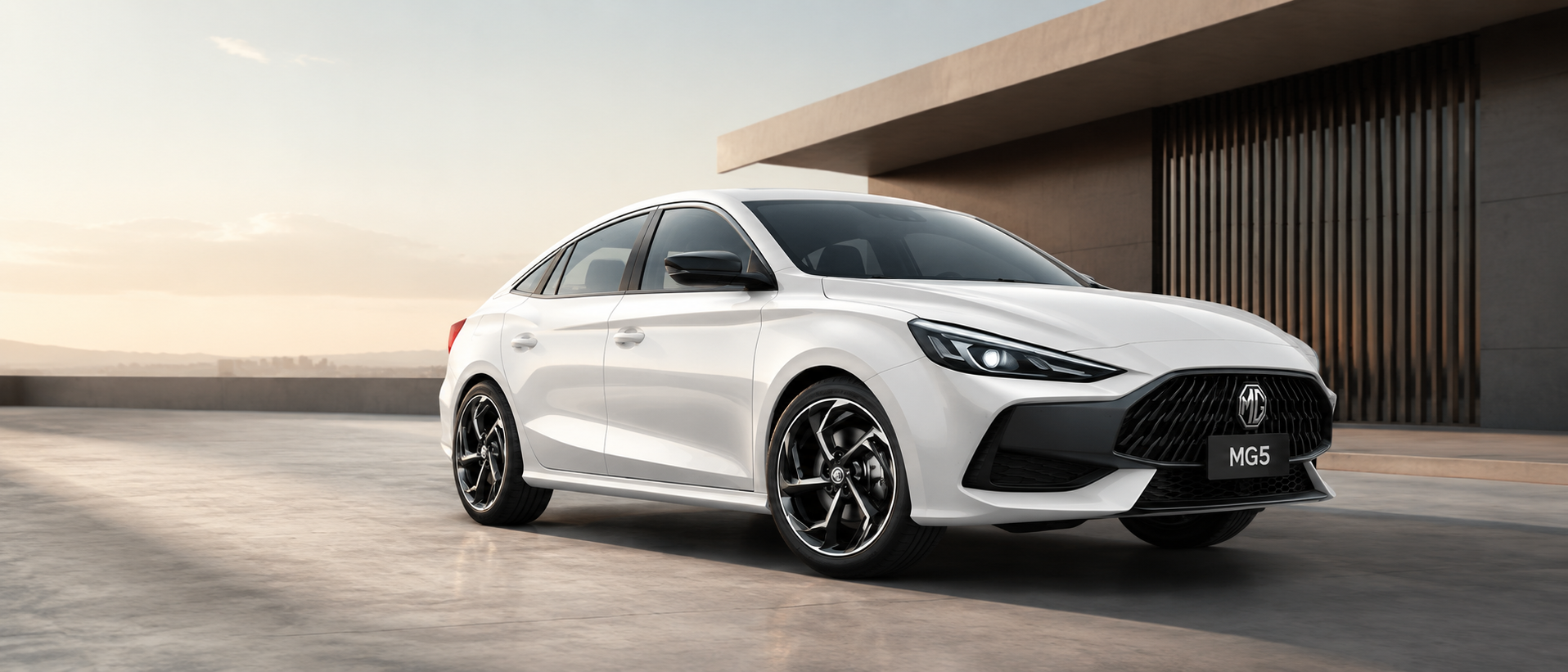 White MG 5 sedan outside a modern building